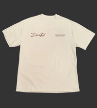Beige t-shirt with 'Devoted' text on a gray background